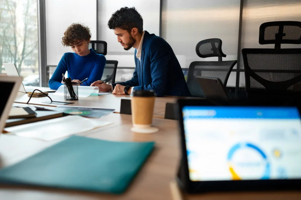 a man and a woman working in the office