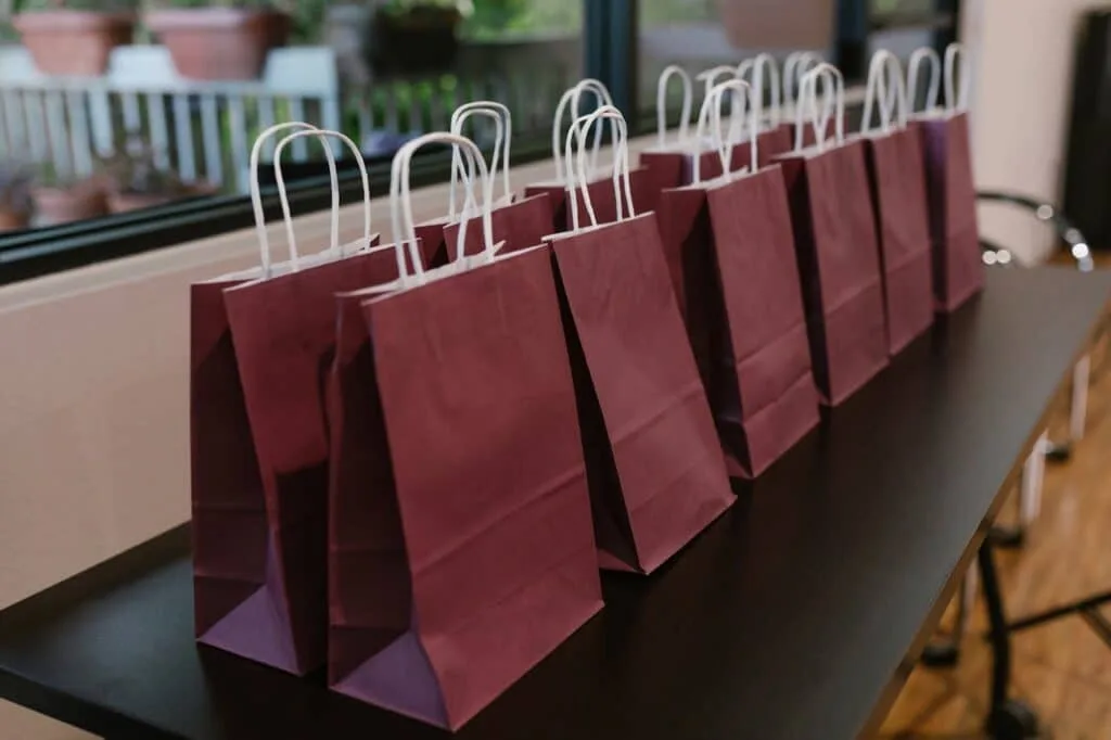 maroon gift bags on top of a table