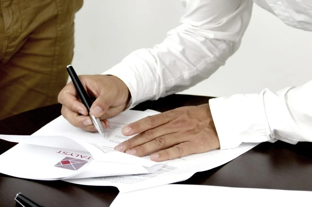 man signing a written contract