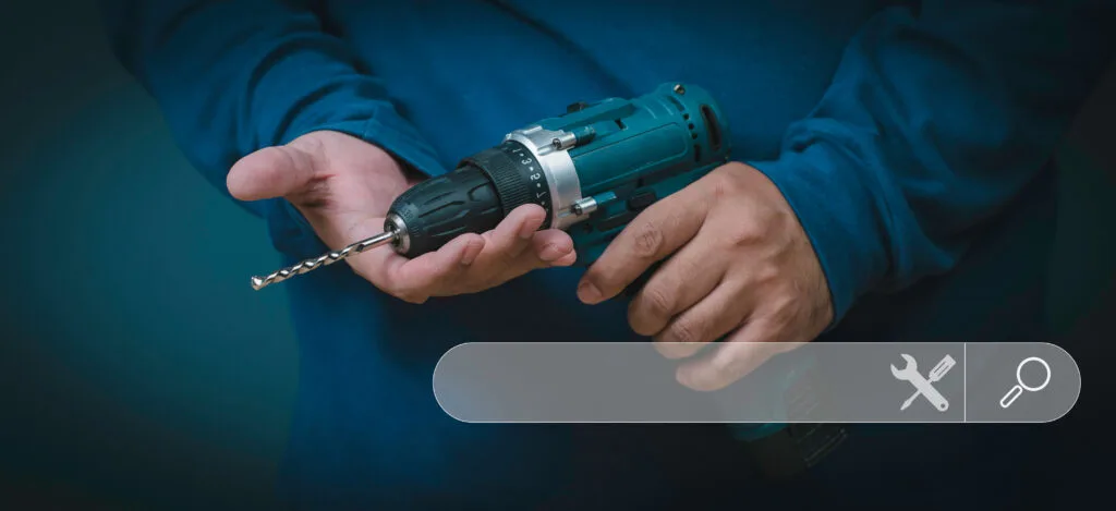 a man holding a drill