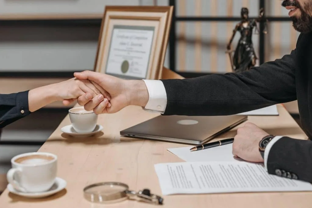 an attorney and client shaking hands