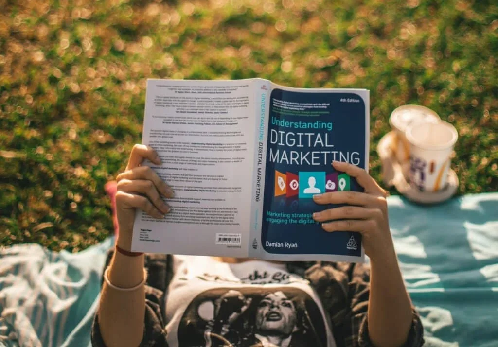 a person holding a book about digital marketing