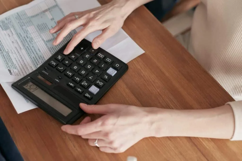 a person using a calculator for invoicing