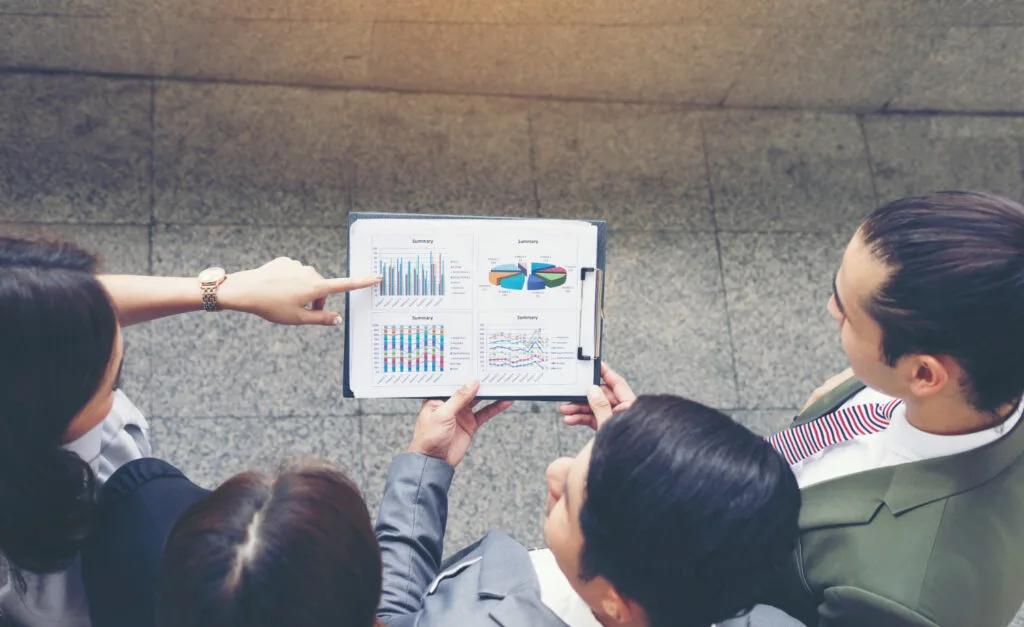 people looking at graphs and analysis