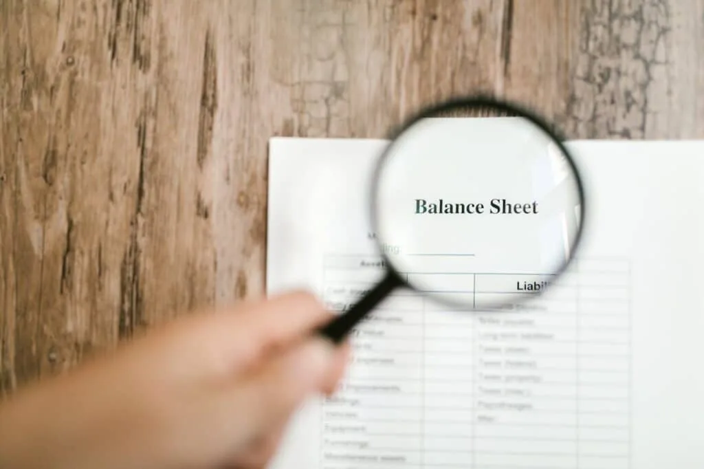 the word balance sheet on a magnifying glass